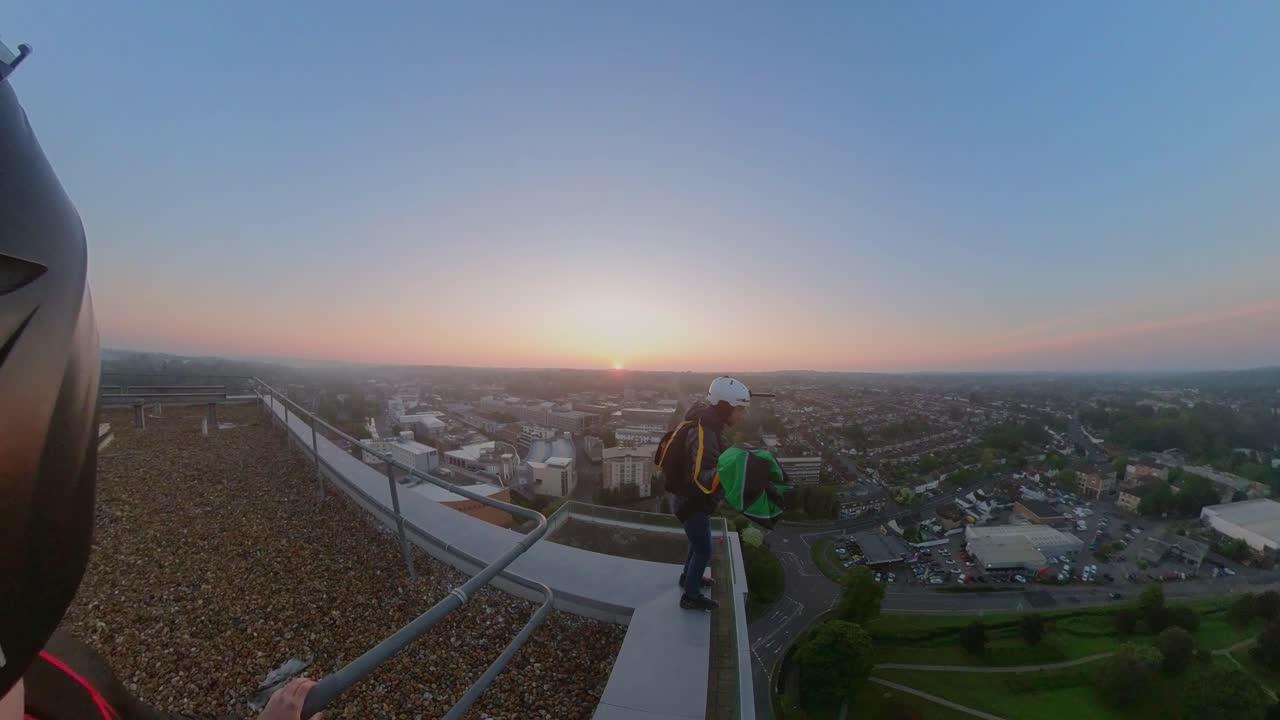 Base Jumpers Flip From Roof Top During an Early Sunrise